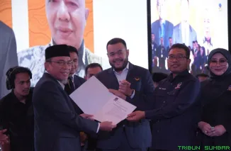 Maigus Nasir menerima SK sebagai Ketua DPD Partai NasDem Kota Padang dari Ketua DPW NasDem Sumbar, Fadly Amran, pada Rakerwil Partai NasDem di Hotel Santika Padang, Minggu (5/10/2025). (Foto: Ist)