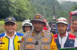 Petugas kepolisian mengatur arus lalu lintas saat uji coba pembukaan Jalur Lembah Anai pascabencana, dengan sistem buka-tutup dan pengamanan ketat, Selasa (16/12/2025). (Foto: Ist)